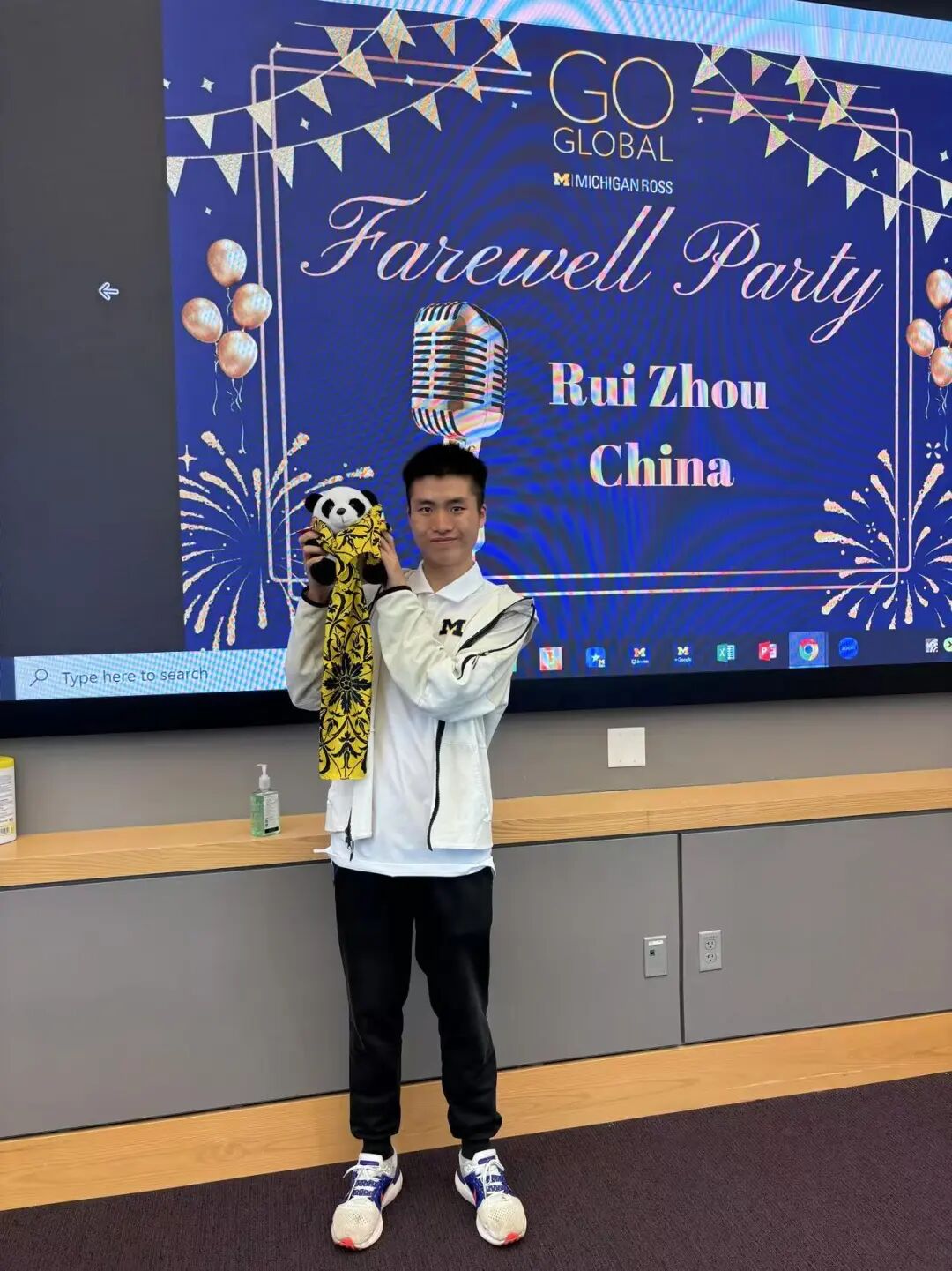 Ross 商学院告别派对上举着熊猫玩偶合影留念