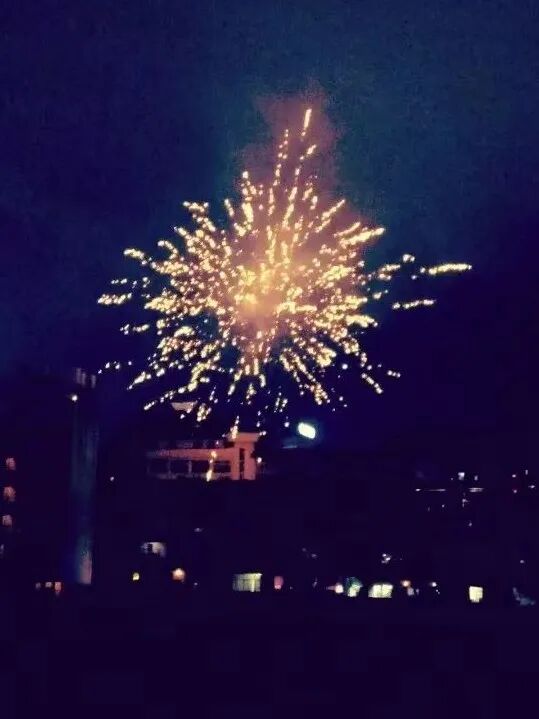元宵节夜晚城市上空绽放的金色烟花